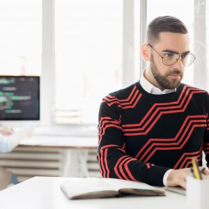 Concentrated copywriter working with laptop